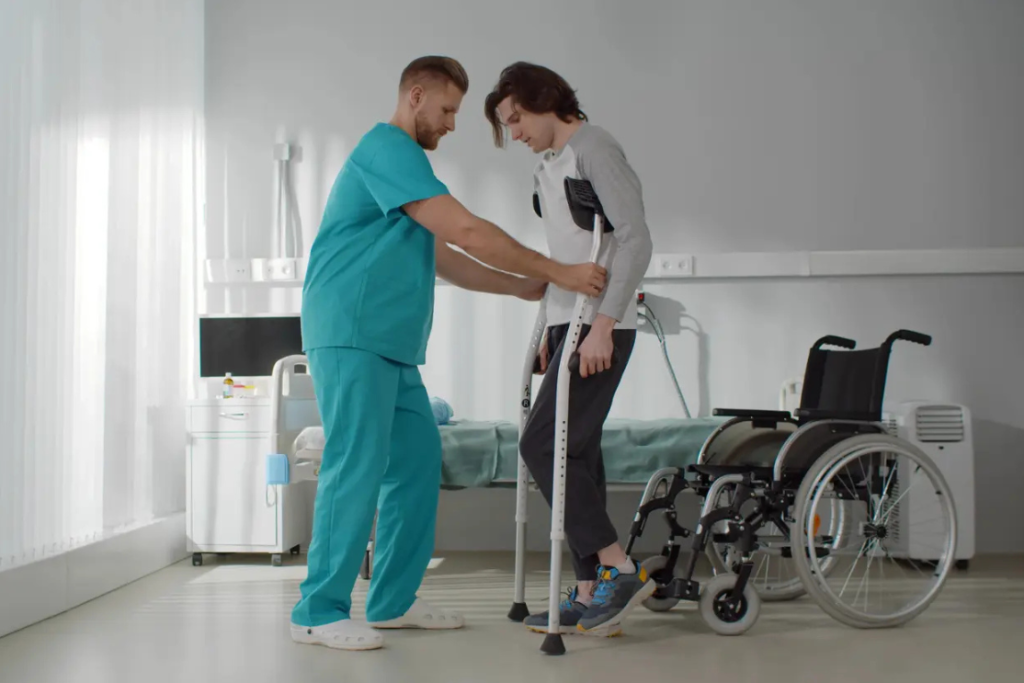 male nurse helping participant in crutches learn to walk