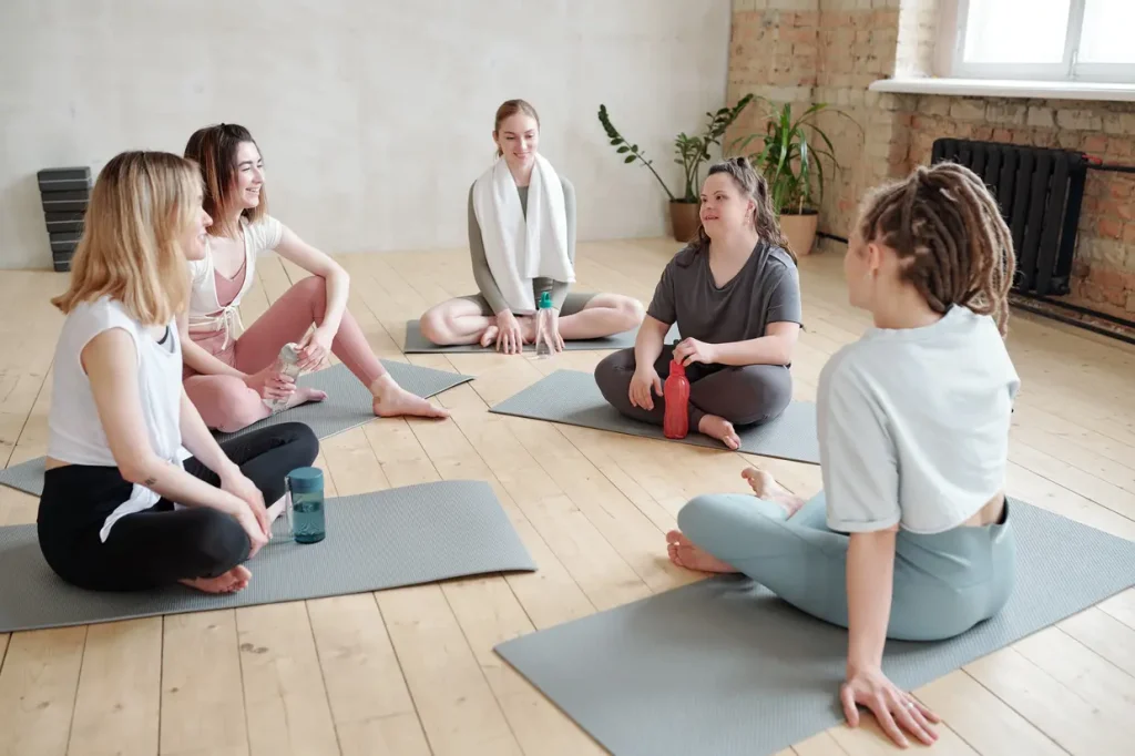 woman with Down syndrome sitting in a circle with friends at a group yoga class